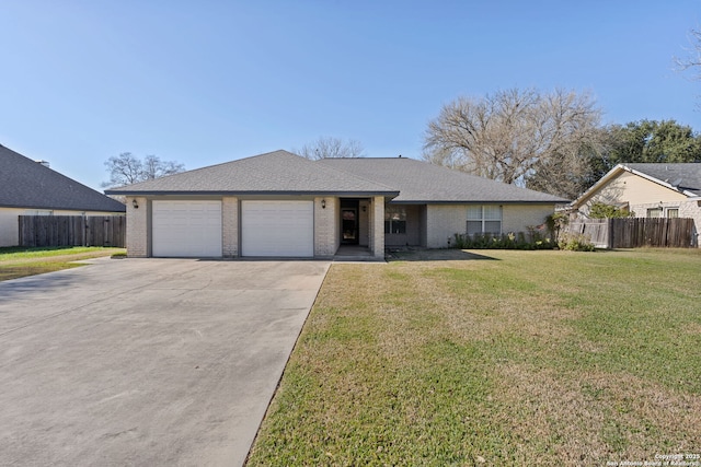 ranch-style house with a garage and a front lawn