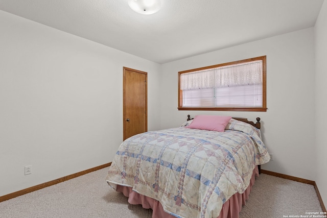 carpeted bedroom with a textured ceiling