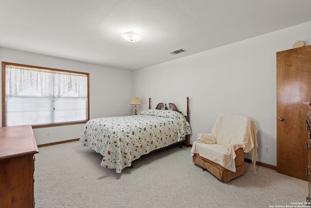 bedroom featuring a textured ceiling and carpet flooring