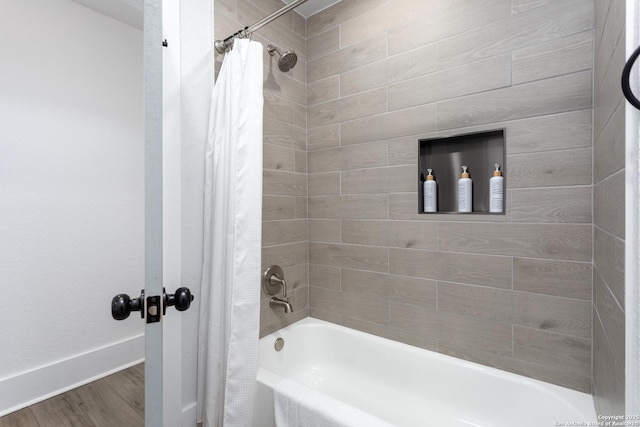 bathroom with hardwood / wood-style floors and shower / bathtub combination with curtain