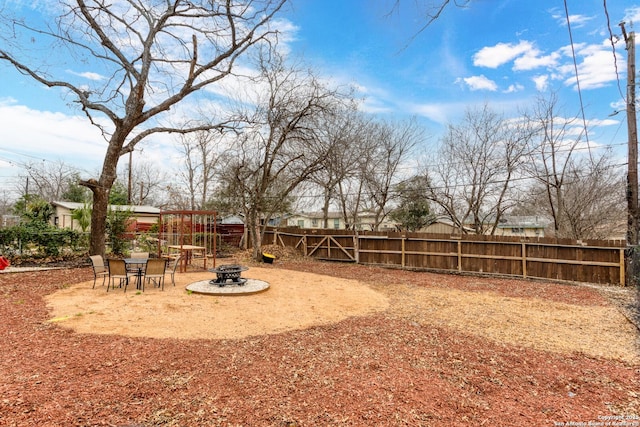 view of yard featuring a fire pit and a patio area