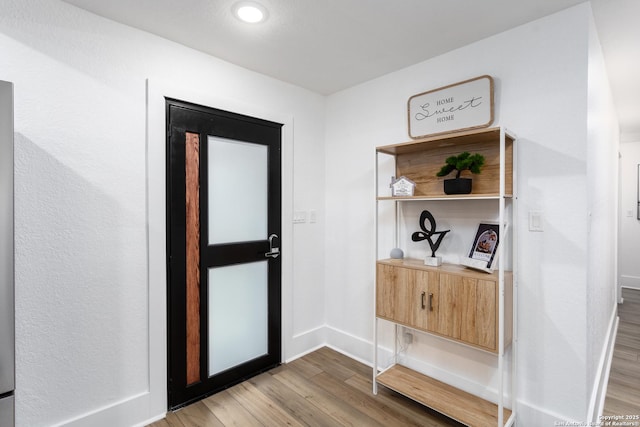 entryway with hardwood / wood-style flooring