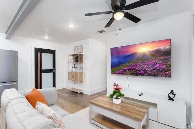 living room featuring hardwood / wood-style floors and ceiling fan