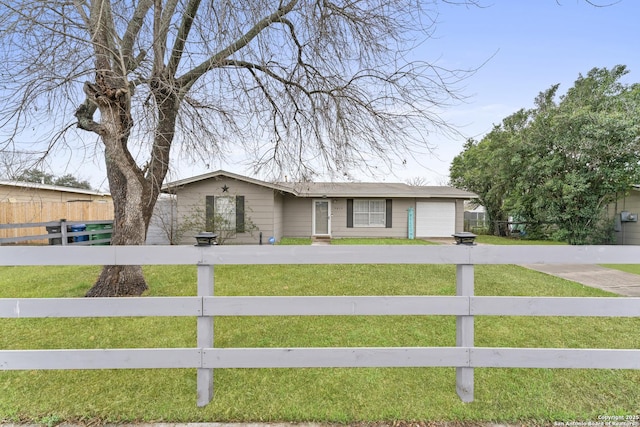 ranch-style home with a garage and a front yard