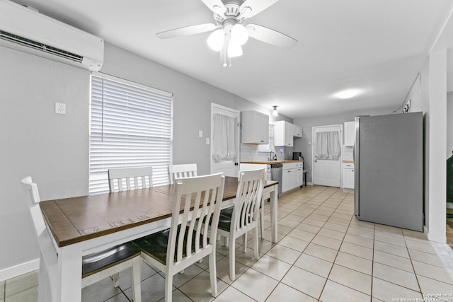 tiled dining room featuring ceiling fan, sink, and a wall mounted AC