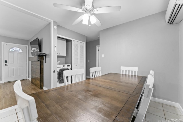 tiled dining area featuring washer / clothes dryer, an AC wall unit, and ceiling fan