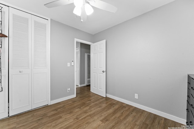 unfurnished bedroom featuring wood-type flooring, a closet, and ceiling fan