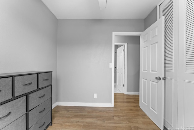 bedroom featuring a closet, ceiling fan, and light hardwood / wood-style flooring