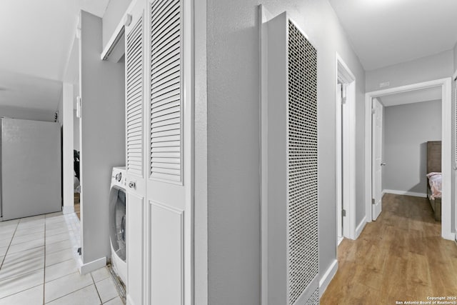 laundry area featuring washer / dryer and light tile patterned floors