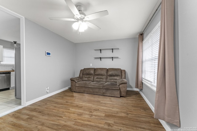 living room featuring ceiling fan and light wood-type flooring