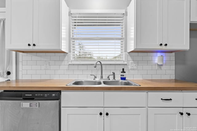 kitchen featuring sink, stainless steel dishwasher, and white cabinets