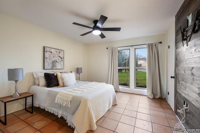 tiled bedroom featuring ceiling fan