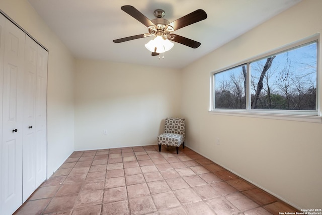 interior space with light tile patterned flooring and ceiling fan