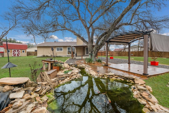 view of yard featuring a wooden deck, a storage shed, and a pergola