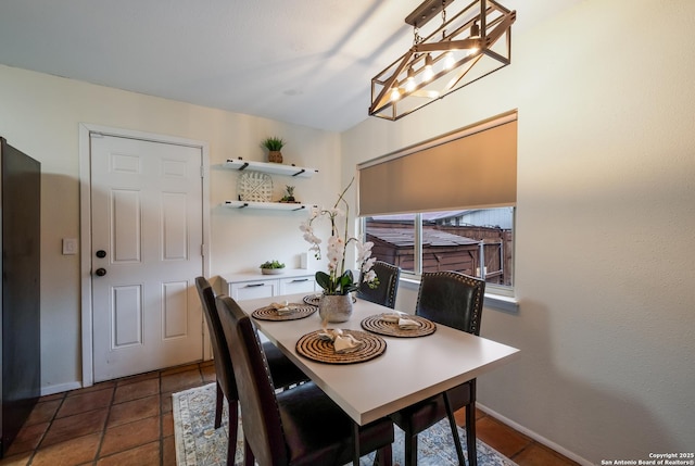 tiled dining room featuring a notable chandelier