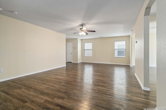 spare room featuring dark hardwood / wood-style floors, a textured ceiling, and ceiling fan