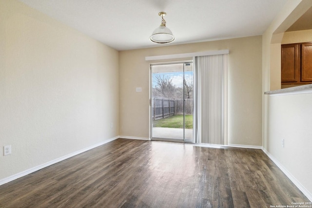 spare room with dark hardwood / wood-style flooring