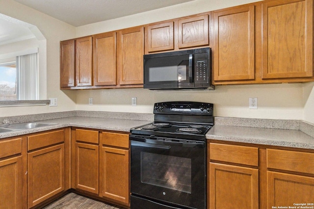 kitchen with sink and black appliances