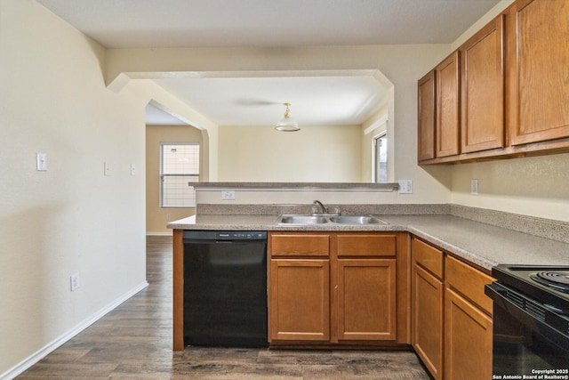 kitchen featuring a healthy amount of sunlight, dark hardwood / wood-style floors, sink, and black appliances