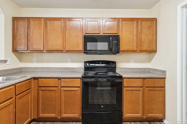 kitchen featuring sink and black appliances