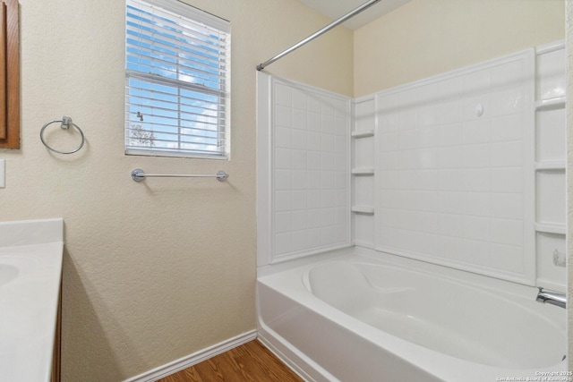 bathroom featuring hardwood / wood-style flooring and shower / bathtub combination