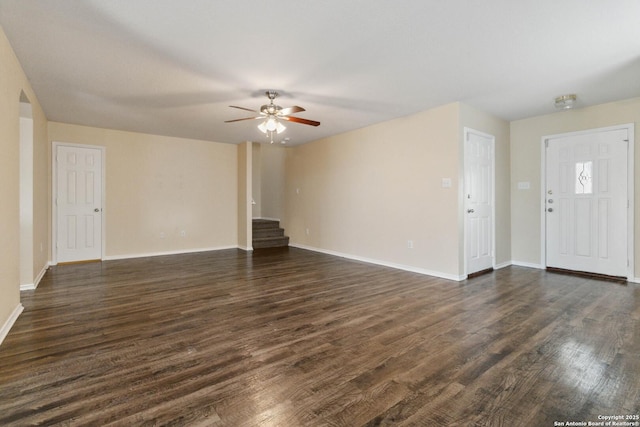 unfurnished living room featuring ceiling fan and dark hardwood / wood-style flooring