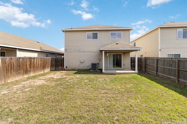 back of house featuring central AC, a patio area, and a lawn