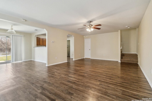 empty room with dark hardwood / wood-style floors and ceiling fan