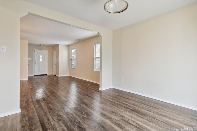 empty room with dark hardwood / wood-style flooring