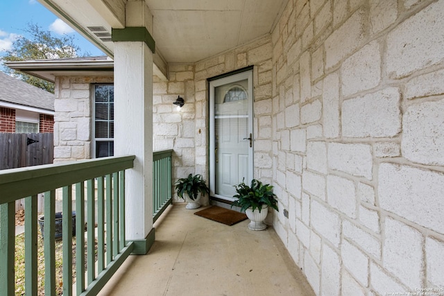 view of exterior entry featuring a balcony