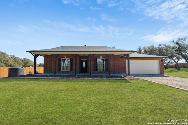 ranch-style house featuring a garage and a front lawn