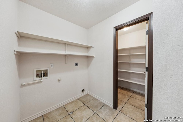 laundry area featuring light tile patterned flooring, gas dryer hookup, a textured ceiling, hookup for a washing machine, and hookup for an electric dryer