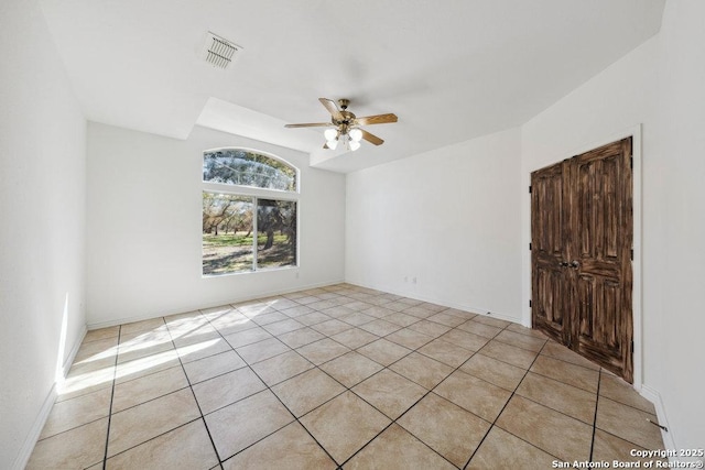 tiled empty room with ceiling fan