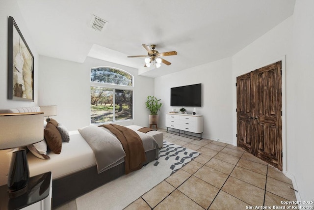 bedroom featuring light tile patterned flooring and ceiling fan