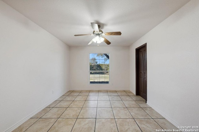 tiled empty room featuring a textured ceiling and ceiling fan