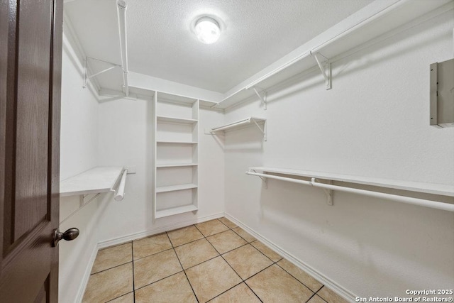 spacious closet with light tile patterned floors