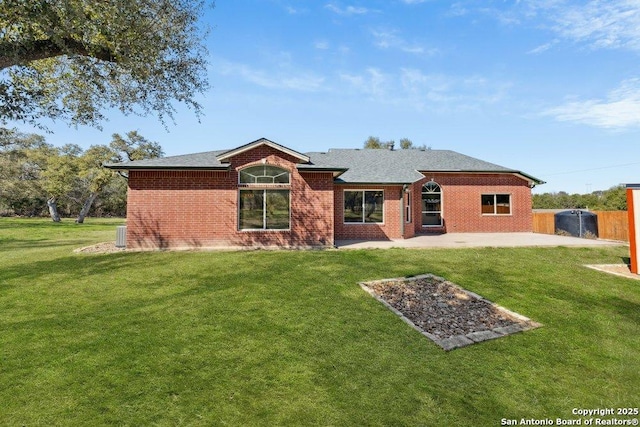 back of house with a yard and a patio area