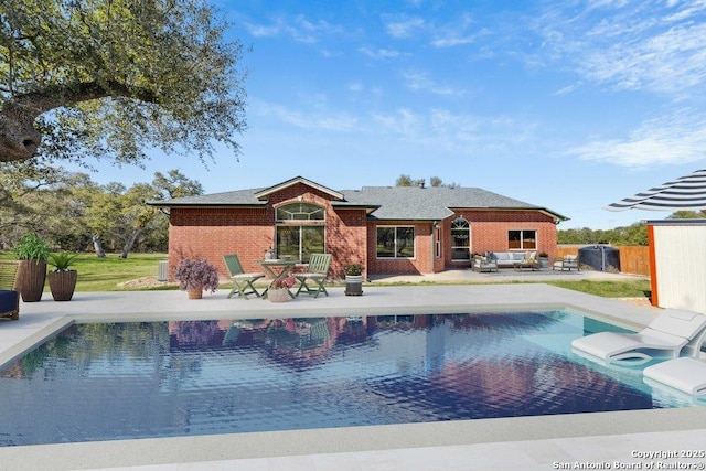 view of pool with an outdoor living space, a jacuzzi, and a patio area