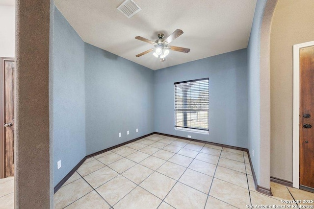 spare room with light tile patterned floors and ceiling fan