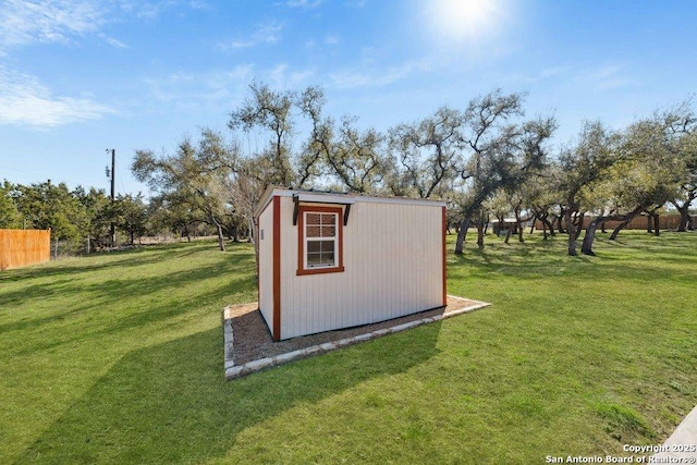 view of outbuilding featuring a lawn