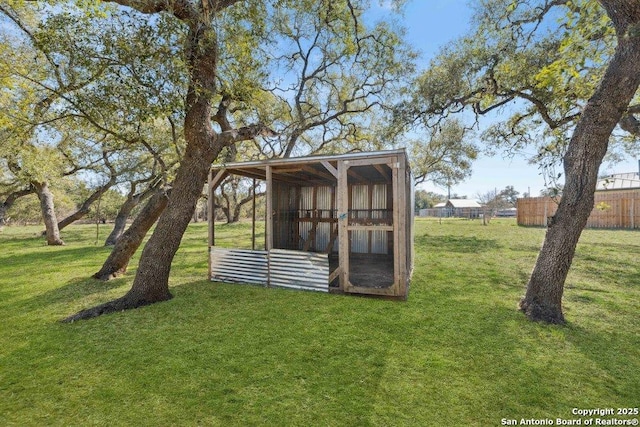 view of outdoor structure featuring a lawn