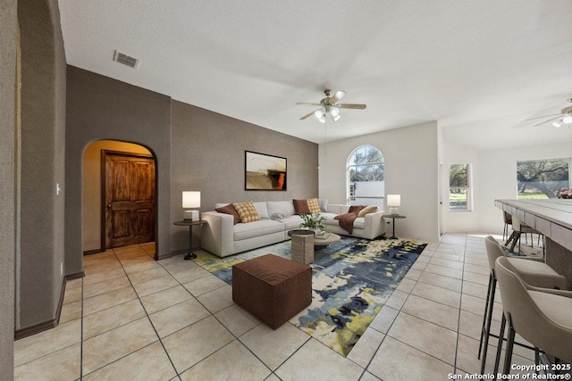 tiled living room featuring ceiling fan