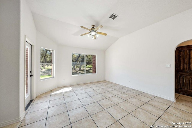 unfurnished room with ceiling fan, lofted ceiling, and light tile patterned floors