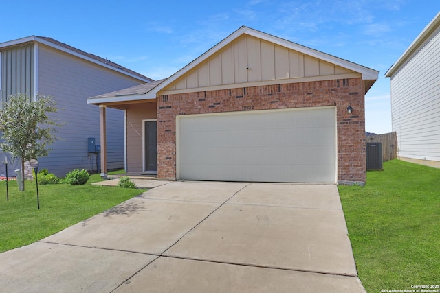 view of front of property with a garage, central AC unit, and a front yard