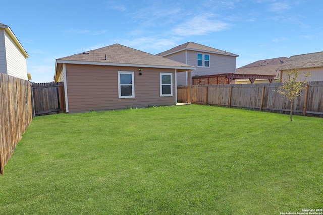 back of house with a lawn