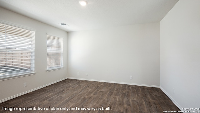 spare room featuring dark hardwood / wood-style floors