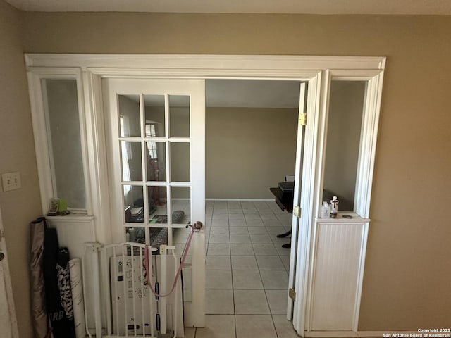 unfurnished office featuring french doors and light tile patterned floors