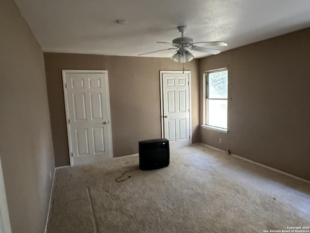 unfurnished bedroom featuring carpet flooring and ceiling fan