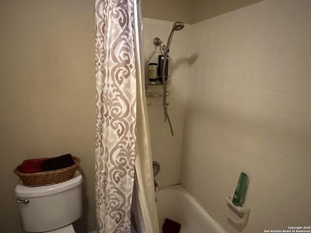 bathroom featuring shower / tub combo with curtain and toilet