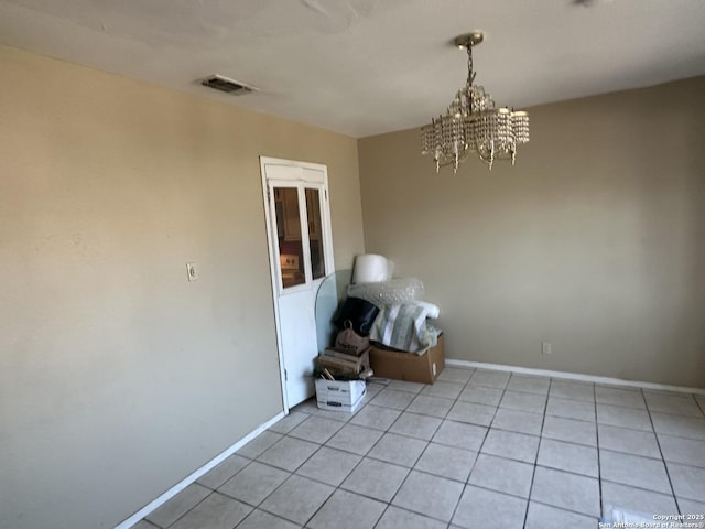 unfurnished room featuring light tile patterned flooring and a chandelier